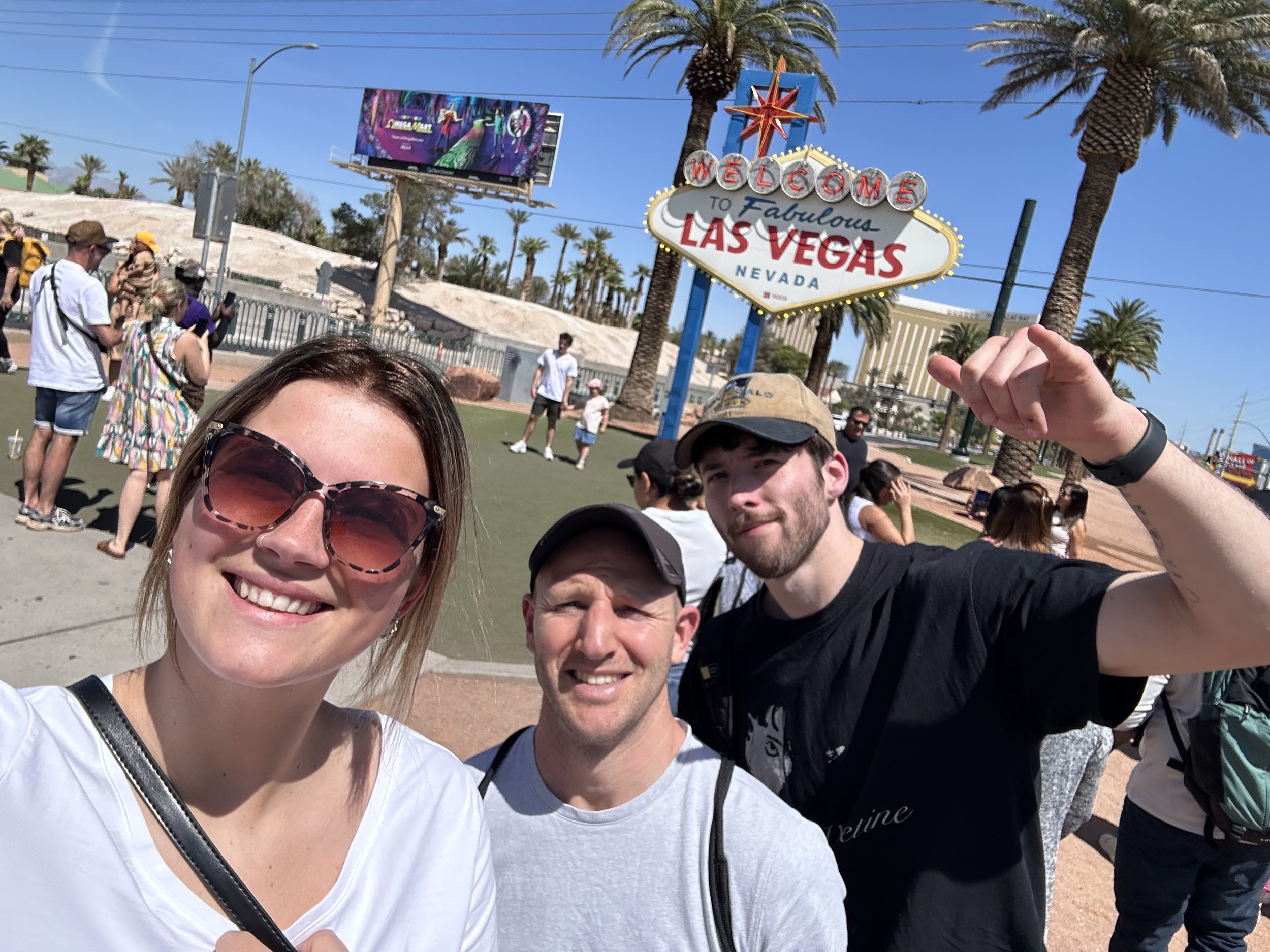 An image of some of our team at in front of a Las Vegas sign