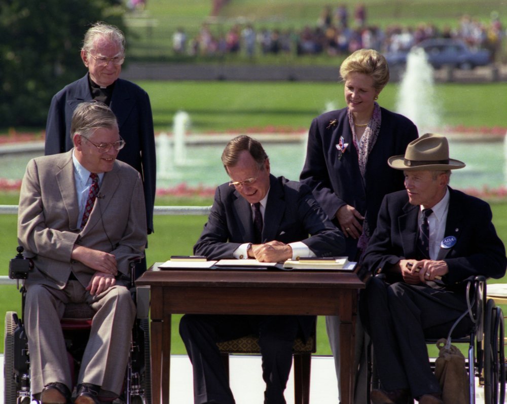 George Bush signing into law the Americans with Disabilities Act of 1990.