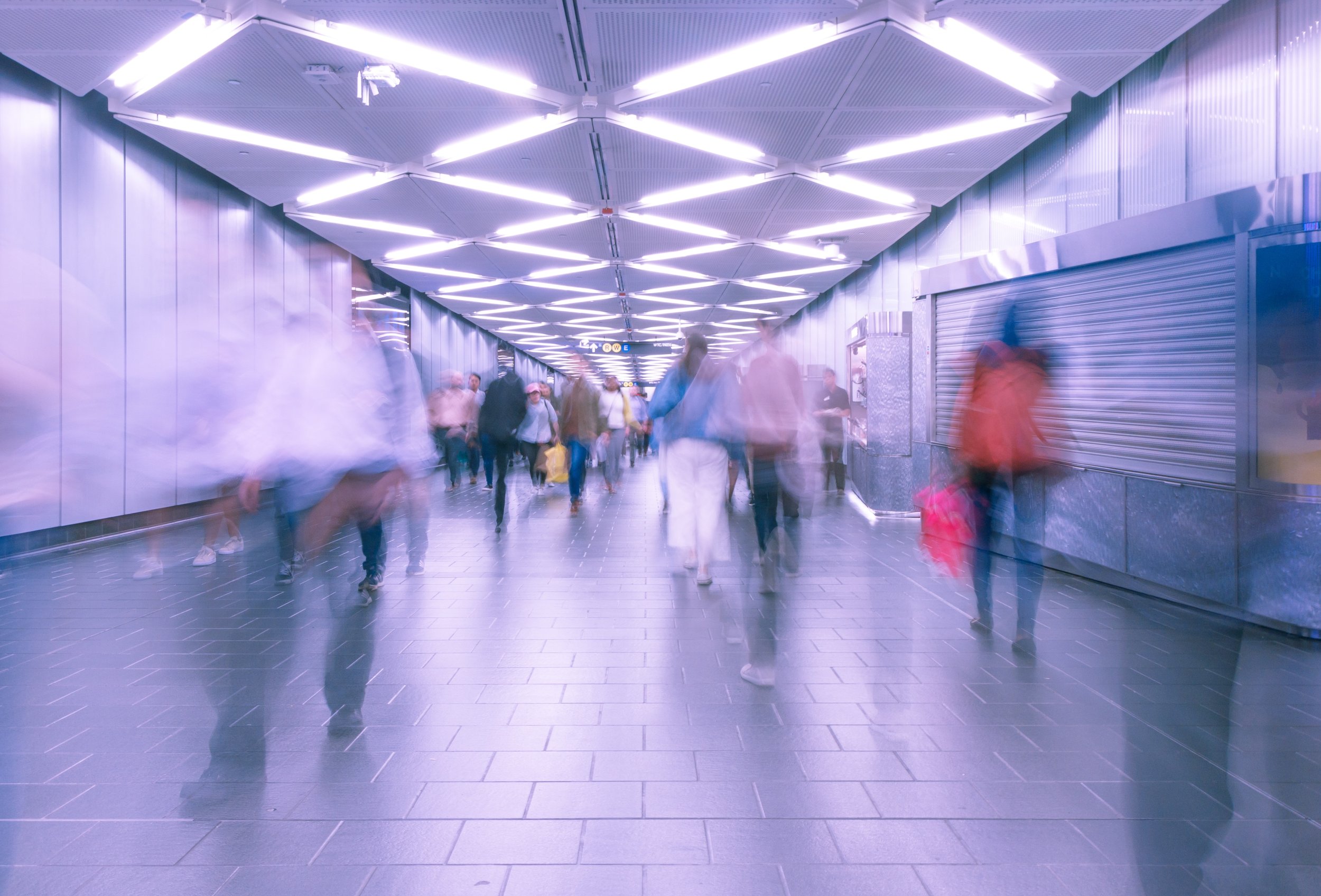 Long exposure (blurry) image of people walking through a subway station in new york, timelapsed